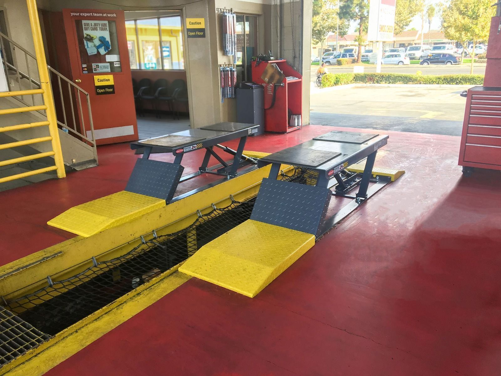 BendPak P-9000LT low-rise pit lifts installed in a service shop