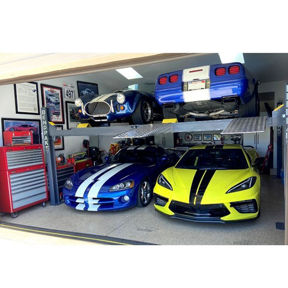 BendPak HD-9SW super-wide four-post lift, four vehicles stored in garage