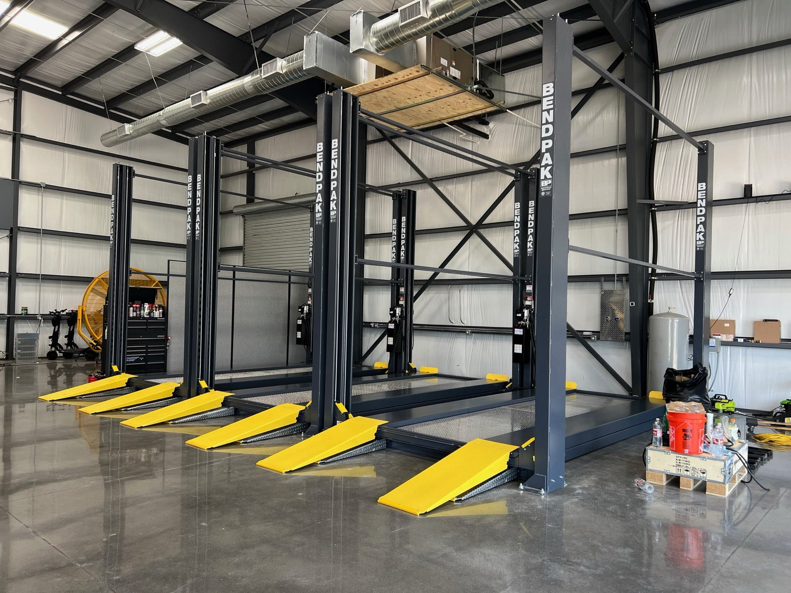 Stocked dealer floor with rows of vehicle lifts